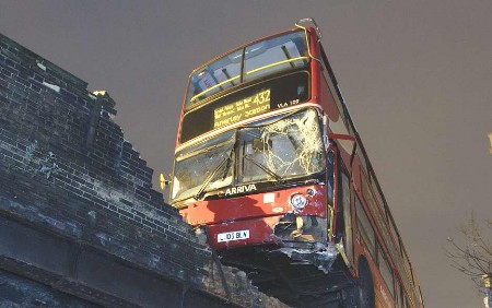 Bus teeters on bridge after fatal crash